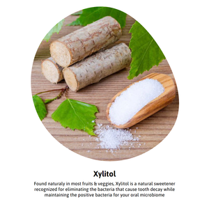 Xylitol sweetener with wooden scoop and birch branches, used for tooth decay prevention in dental supplements.